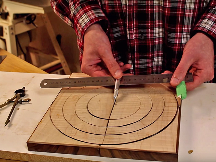 Begin laying out the rings by drawing the largest possible circle and work inward.