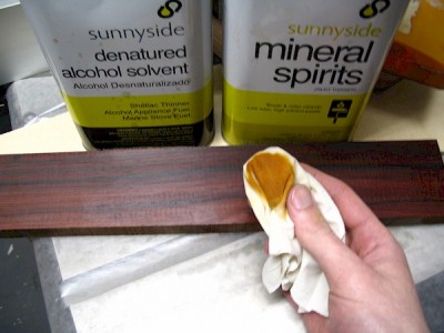 A solvent should lift surface oils from the wood.